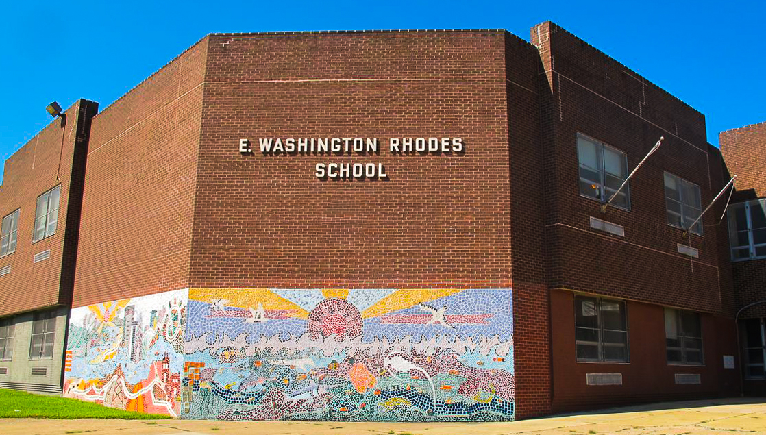 Exterior of E.W. Rhodes School featuring its brick façade and colorful mosaic mural.